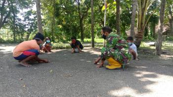Manfaatkan Waktu, Anggota Satgas TMMD Bojonegoro Main Kelereng Bareng Anak-Anak